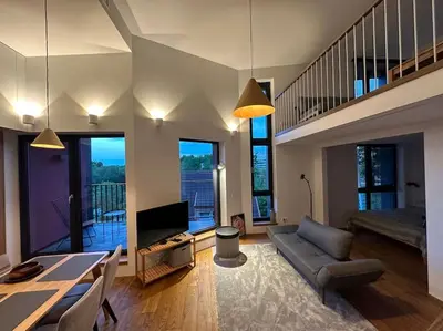 a living room with a couch and a table and a television at Sunny Cosy Home in Kaunas
