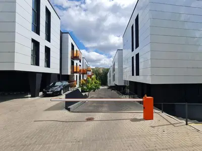 a street between two buildings with a car parked next to it at Sunny Cosy Home in Kaunas