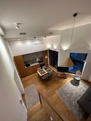 a living room with a couch and a table at Sunny Cosy Home in Kaunas
