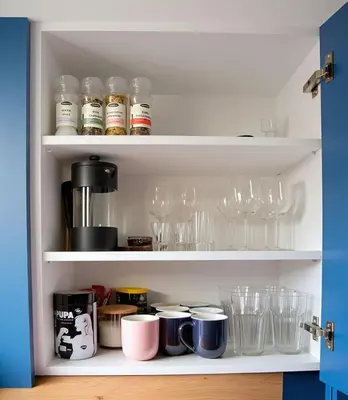 a cupboard filled with glasses and wine glasses at Cozy Family Apartments in Druskininkai