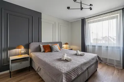 a bedroom with a bed with two teddy bears on it at Central Park Apartments in Birštonas