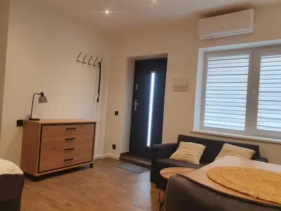 a bedroom with a bed and a couch and a window at Urban Oasis Studios in Kaunas