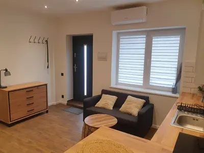 a living room with a couch and a table at Urban Oasis Studios in Kaunas