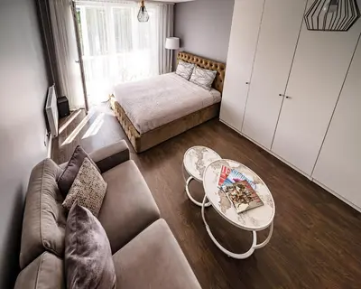 a living room with a couch and a table at Urban Oasis Apartments in Šiauliai