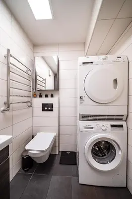 a bathroom with a washing machine and a toilet at Urban Oasis Apartments in Šiauliai