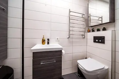 a small bathroom with a sink and a toilet at Urban Oasis Apartments in Šiauliai