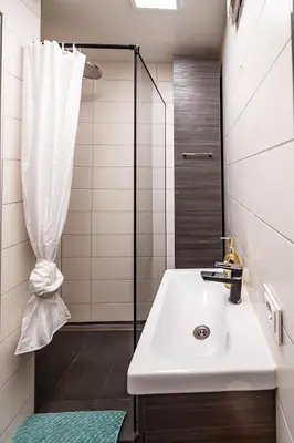 a bathroom with a sink and a shower at Urban Oasis Apartments in Šiauliai