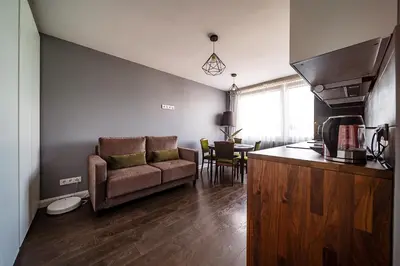 a living room with a couch and a table at Urban Oasis Apartments in Šiauliai