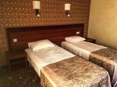 a hotel room with two beds in a room at Pas Radvila in Kaišiadorys