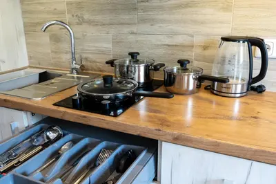 a kitchen counter with pots and pans on a stove at Park's Edge apartment in Kaunas