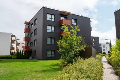an apartment building with a green yard at Park's Edge apartment in Kaunas