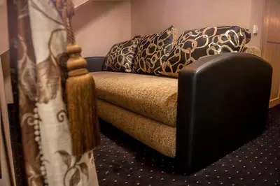 a couch with pillows on it in a room at Kambarių nuoma Žasliuose in Žasliai
