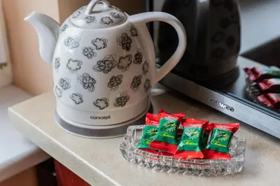 a pile of christmas presents next to a teapot at Monic Apartments in Šiauliai