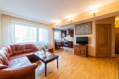a living room with a couch and a table at Monic Apartments in Šiauliai