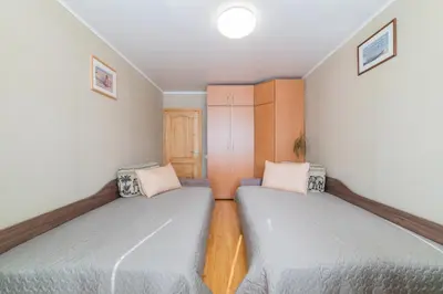 two beds in a small room with two bedsvisor at Monic Apartments in Šiauliai