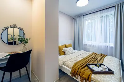 a small bedroom with a bed and a desk at Pailsėk Rasytės oazėje, Kaune in Kaunas