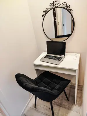 a mirror and a laptop on a desk with a chair at Pailsėk Rasytės oazėje, Kaune in Kaunas
