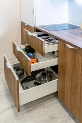 a kitchen with an open drawer with a stove at Pailsėk Rasytės oazėje, Kaune in Kaunas