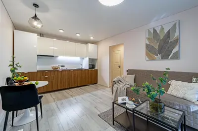 a living room with a couch and a table at Pailsėk Rasytės oazėje, Kaune in Kaunas