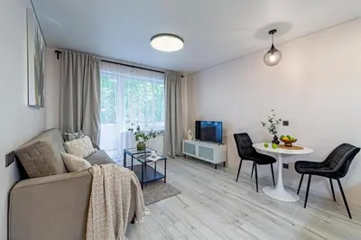 a living room with a couch and a table at Pailsėk Rasytės oazėje, Kaune in Kaunas