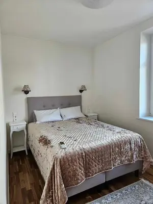 a bedroom with a large bed in a room at Suncity apartamentai in Šiauliai