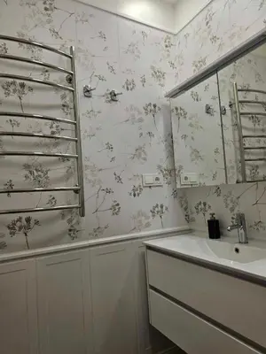 a bathroom with a sink and a mirror at Suncity apartamentai in Šiauliai