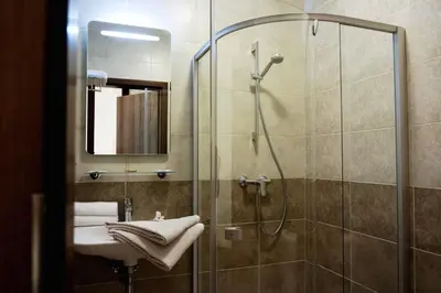 a bathroom with a shower and a sink at Dzūkijos dvaras in Alytus