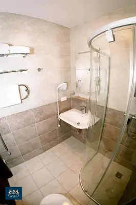 a bathroom with a shower and a sink at Dzūkijos dvaras in Alytus