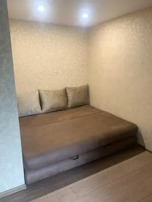 a bed in a corner of a room at Vytauto 36a in Zarasai
