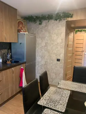 a kitchen with a table and a refrigerator at Vytauto 36a in Zarasai