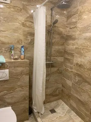 a shower with a shower curtain in a bathroom at Vytauto 36a in Zarasai