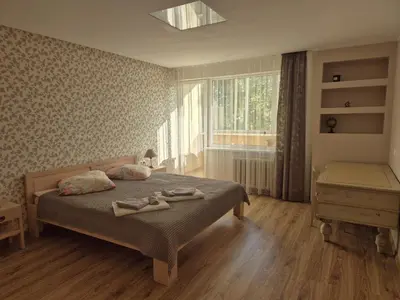a bedroom with a bed with two pairs of shoes on it at Čiurlionis Apartment Druskininkai in Druskininkai