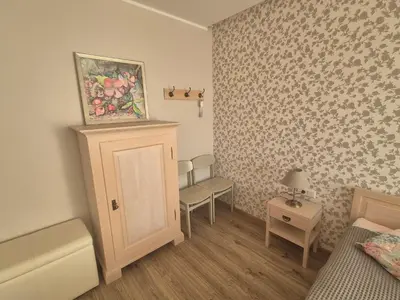 a room with a bed and a painting on the wall at Čiurlionis Apartment Druskininkai in Druskininkai