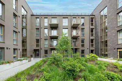 an apartment building with a courtyard with plants at Žalia kopa in City center in Vilnius