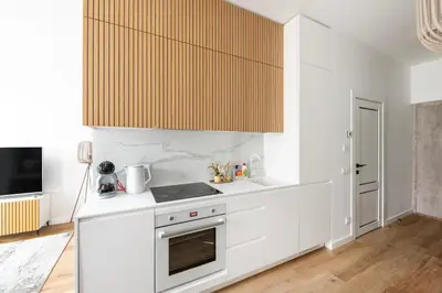 a kitchen with white cabinets and a stove at Žalia kopa in City center in Vilnius