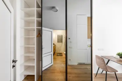 a room with a dining table and a glass door at Žalia kopa in City center in Vilnius