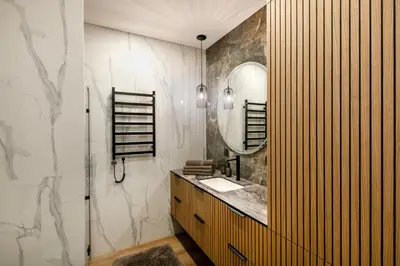 a bathroom with a sink and a mirror at Žalia kopa in City center in Vilnius