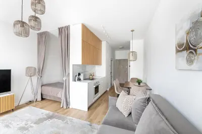 a living room with a couch and a table at Žalia kopa in City center in Vilnius