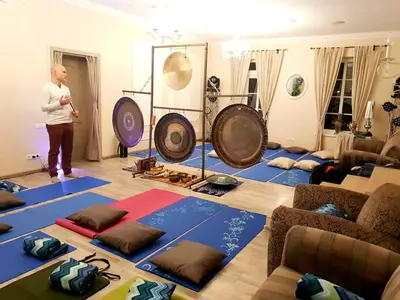 a woman is standing in a room with yoga mats at Provansalio dvaras in Babriškės
