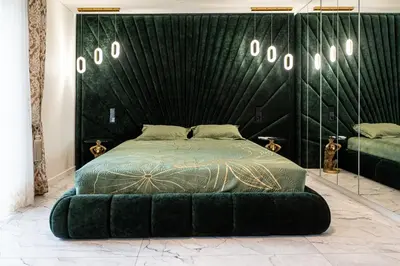 a bedroom with a green bed with a black wall at AMJ Royal Apartments - 110 - Latte in Kaunas