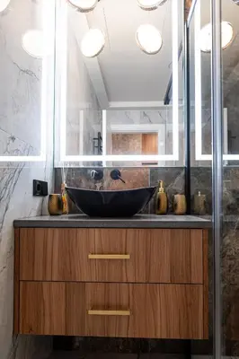 a bathroom with a black bowl sink on a counter at AMJ Royal Apartments - 110 - Latte in Kaunas
