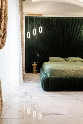 a bedroom with a green bed and a black wall at AMJ Royal Apartments - 110 - Latte in Kaunas
