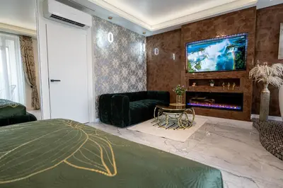 a bedroom with a bed and a tv on a wall at AMJ Royal Apartments - 110 - Latte in Kaunas