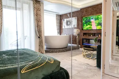 a living room with a tub and a tv at AMJ Royal Apartments - 110 - Latte in Kaunas