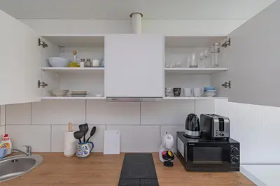 a kitchen with a sink and a microwave at Partizanų studio apartment #2 by Polo Apartments in Kaunas
