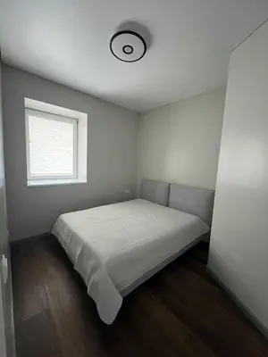 a bedroom with a bed and a window at Patrick in Šveicarija