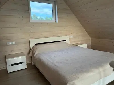 a bedroom with a bed and a window at Zanapolio ranča in Norvaišiai