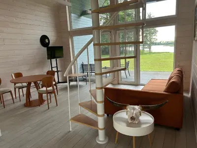 a living room with a cow head on a table at Zanapolio ranča in Norvaišiai