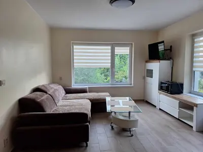 a living room with a couch and a refrigerator at Rent Olamit in Karkazai