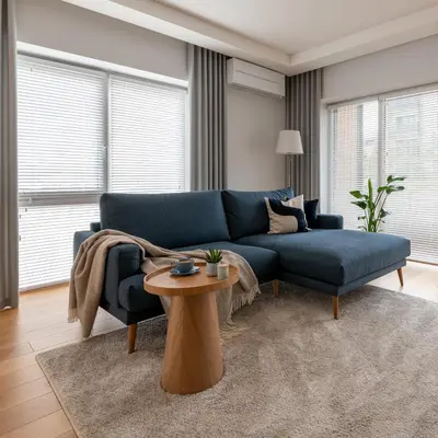 a living room with a blue couch and a table at D33 Vilnius - Brand New Luxury Apartment with Terrace, Garden, AC and Parking in Vilnius